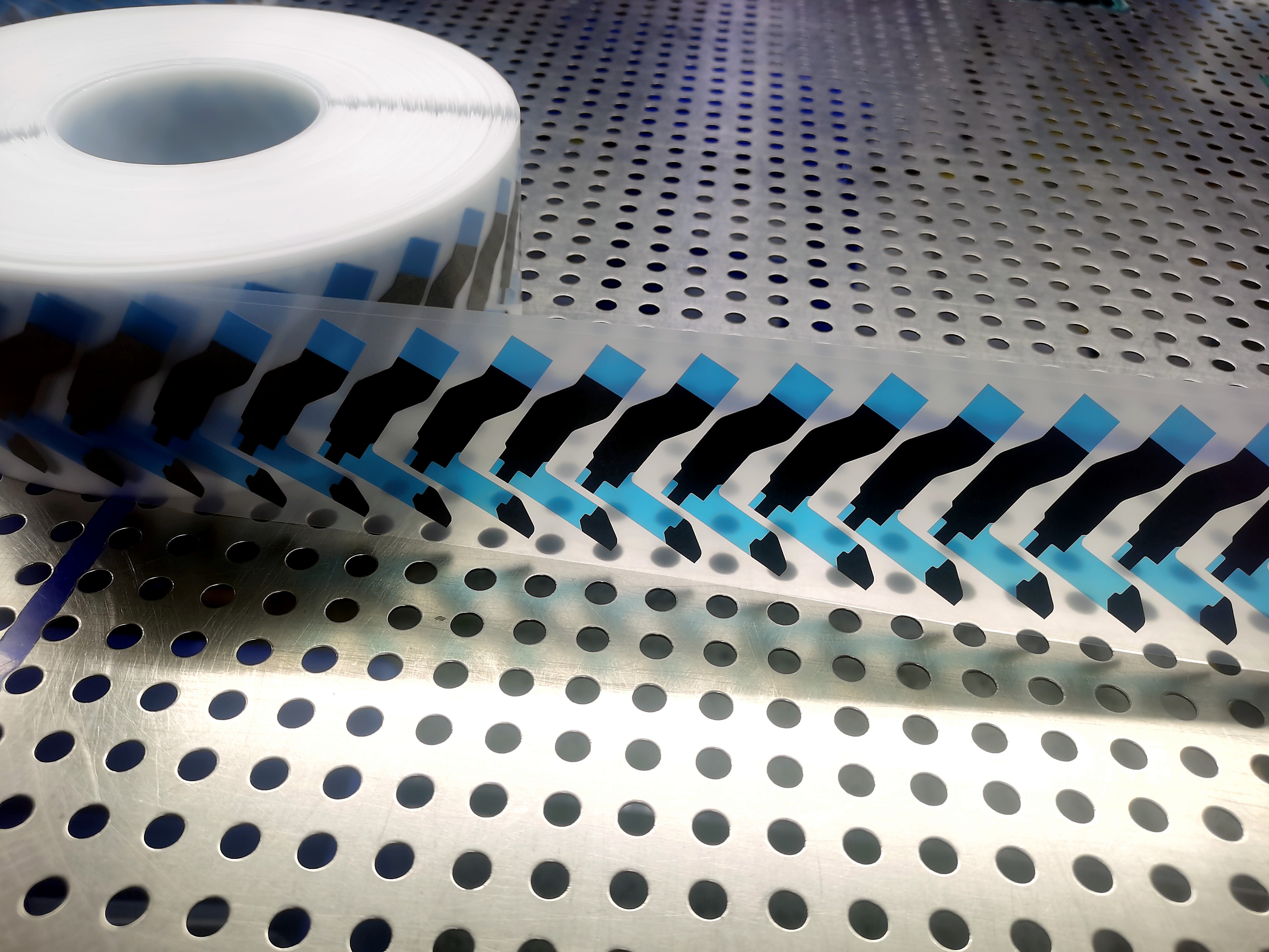 Roll-fed die-cut double-sided tape on steel plate